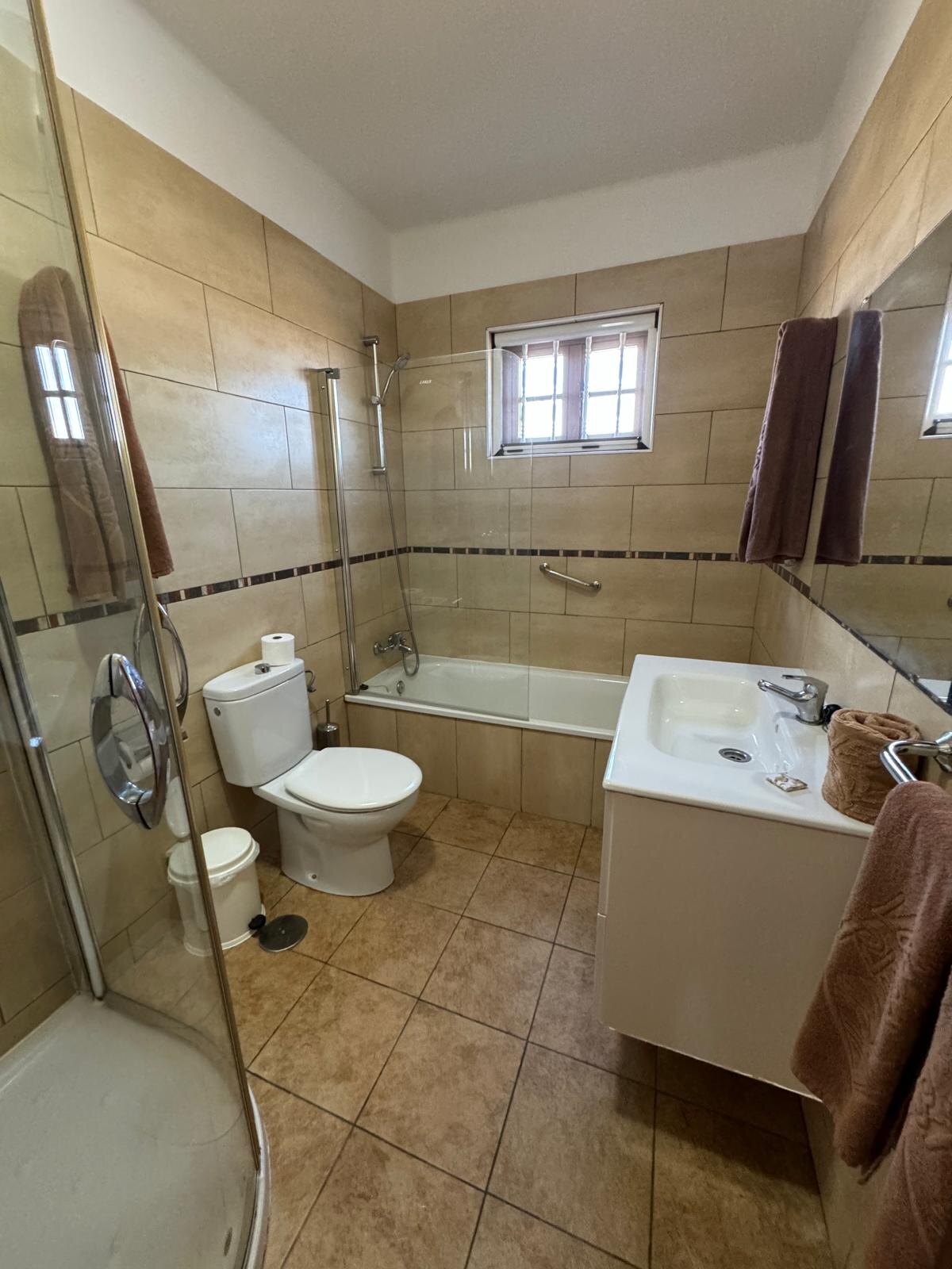 Villa 75 bathroom with bath and separate shower cubicle
